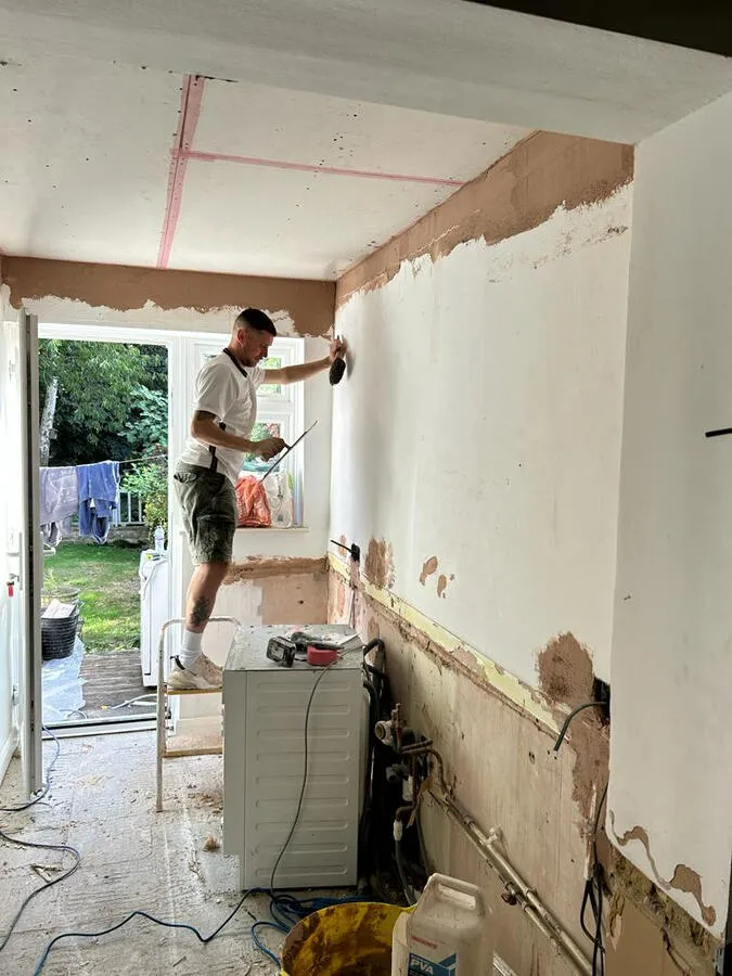 Painter working on interior walls
