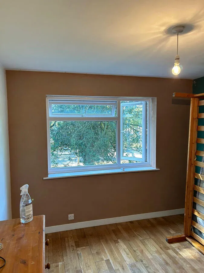 Painted bedroom with brown feature wall