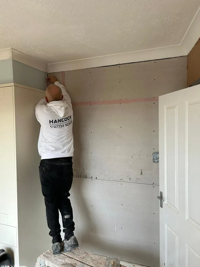 Plasterer working on ceiling detail